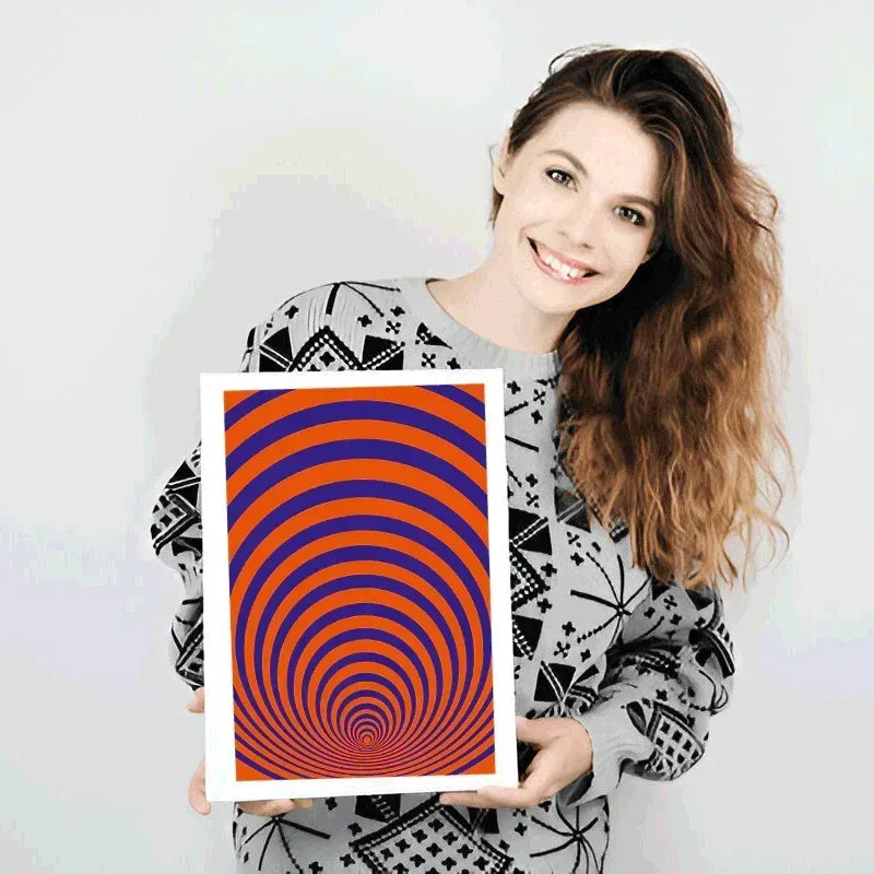Woman holding a framed artwork with orange and blue spiral design on a white background