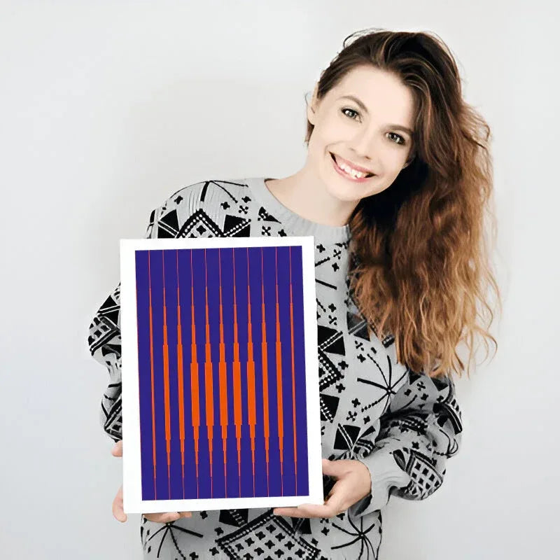 Woman holding a colorful abstract art print against a plain background
