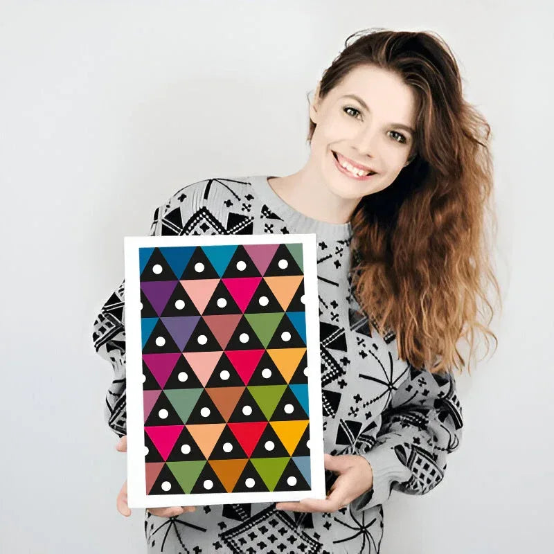 Woman holding a colorful geometric patterned frame against a white background