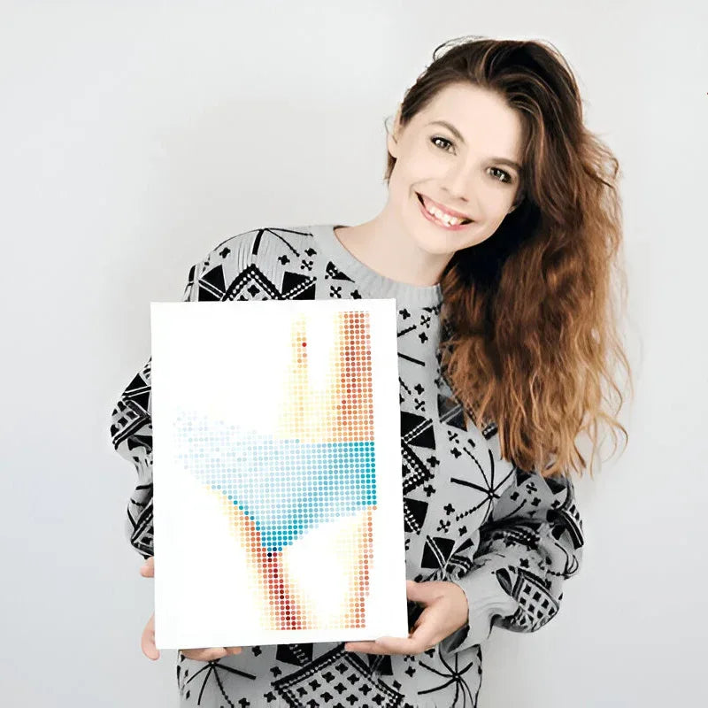 Woman holding a colorful abstract art print against a plain background