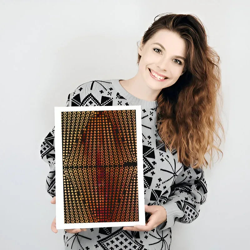 Woman holding a framed artwork with geometric pattern on a plain background