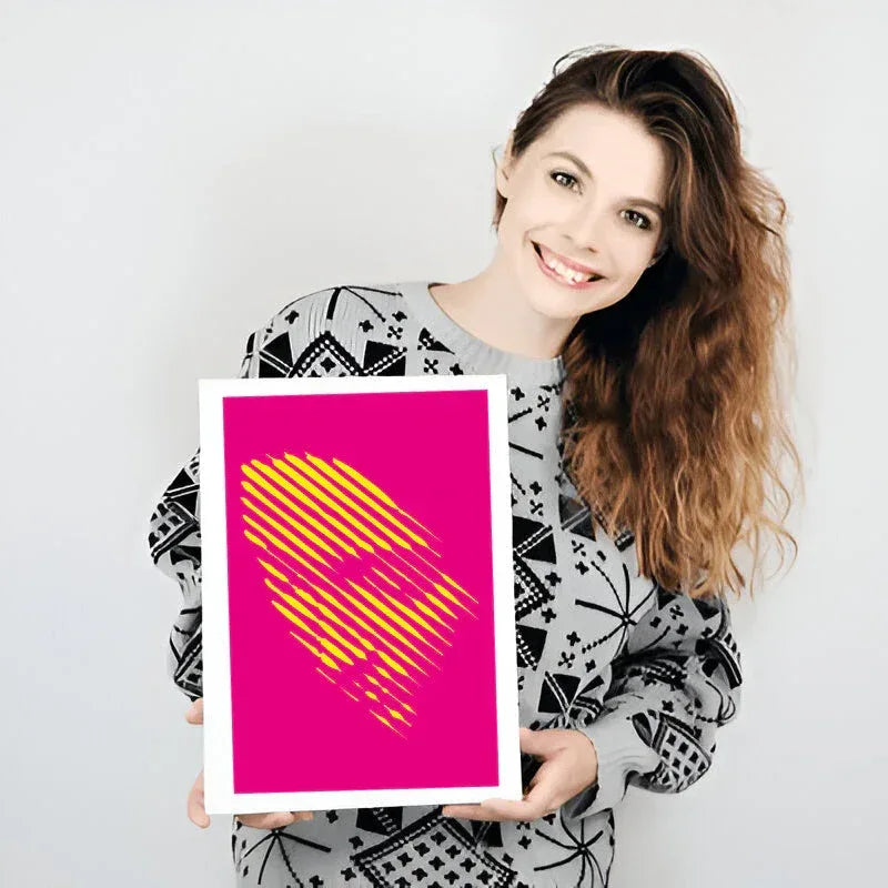Woman holding a pink and yellow heart-shaped poster against a white background