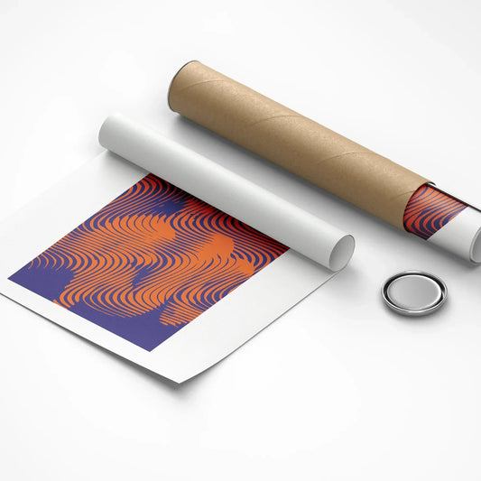 Roll of paper with a pattern, cardboard tube, and round metallic object on a white background