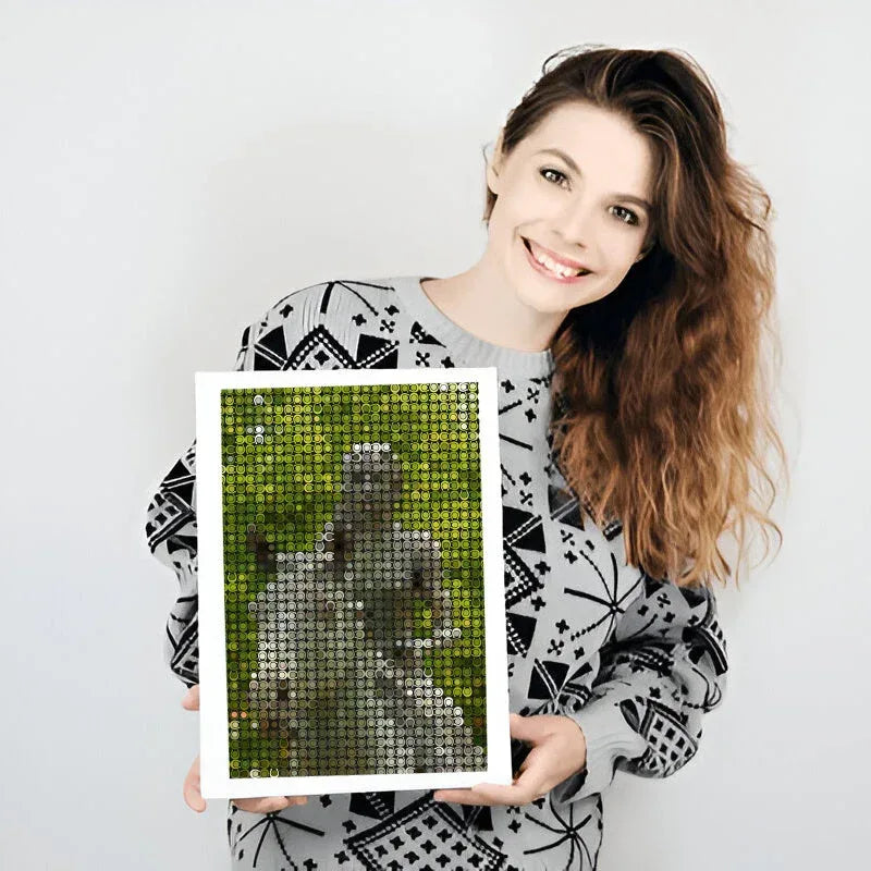 Woman holding a framed mosaic artwork of a dog on a grassy field