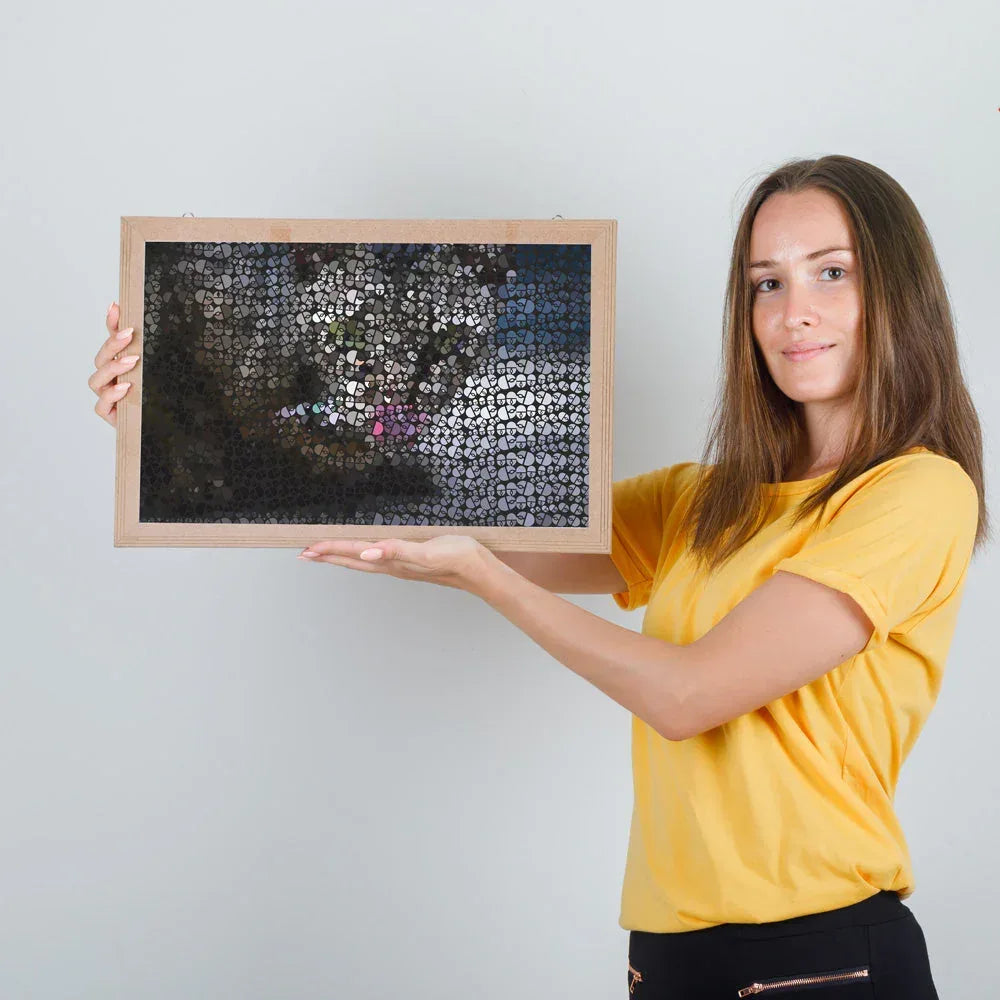 Woman holding a framed mosaic art piece against a plain background