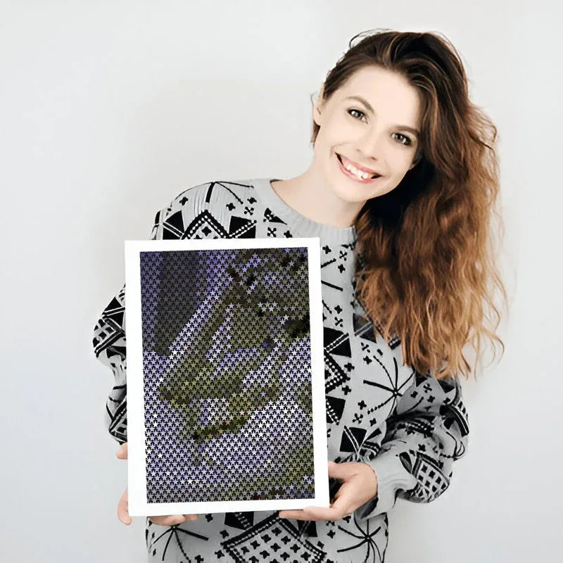 Woman holding a framed picture against a plain background