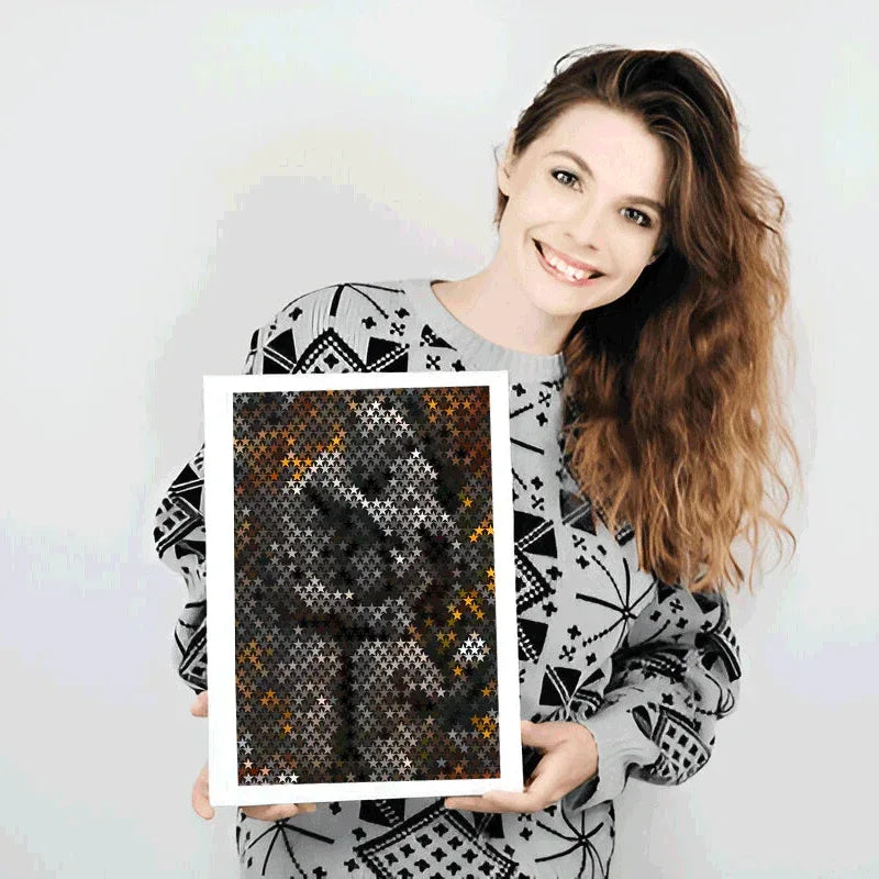 Woman holding a framed pixel art piece against a plain background