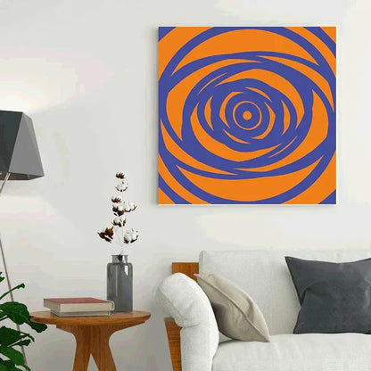 Abstract spiral artwork in orange and blue on a white wall above a sofa.
