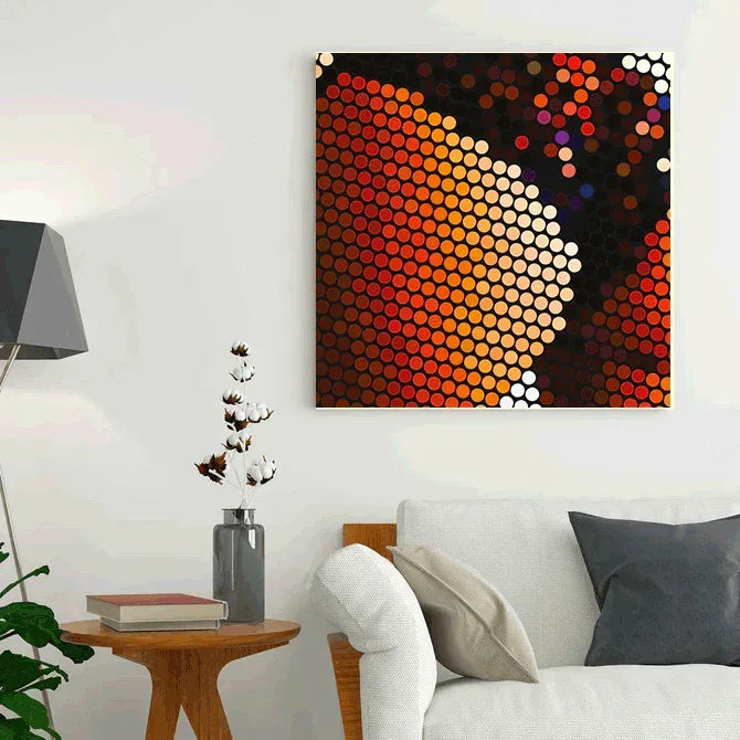 Abstract wall art in a living room with a couch and side table.
