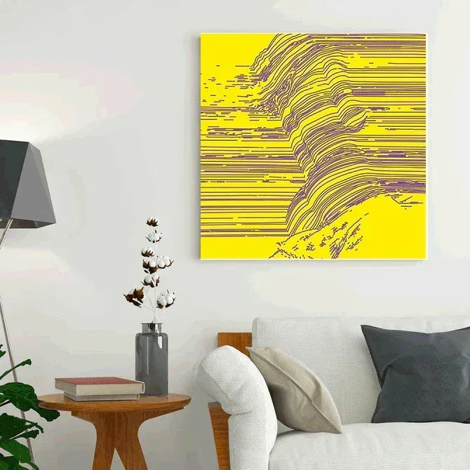 Yellow abstract painting on a white wall above a sofa.