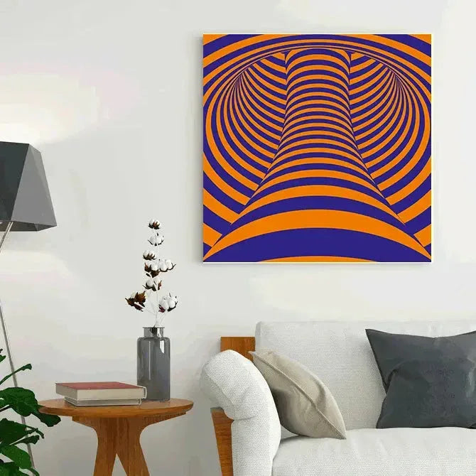 Abstract art piece with orange and blue patterns on a white wall above a sofa.