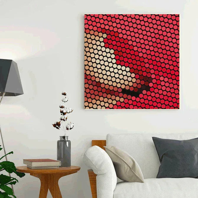 Abstract art piece with red and beige circles on a white wall above a sofa.