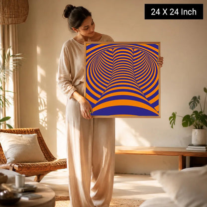 A woman holds a 24x24 inch framed Serenity Meditation Art print featuring vibrant orange and blue concentric patterns, set in