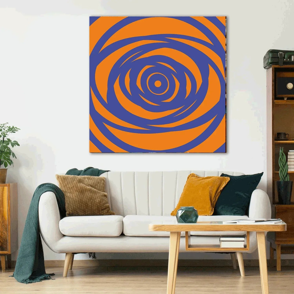 Living room with a white sofa, coffee table, and a large abstract painting of orange and blue concentric circles on the wall.
