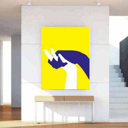 Abstract art print of a hand on a yellow background in a modern interior setting.