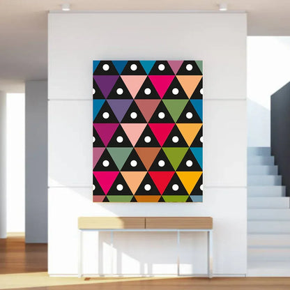 Colorful geometric patterned wall art on a white wall above a wooden console table.