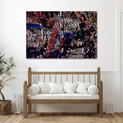 Abstract artwork on a wall above a wooden bench with white cushions.