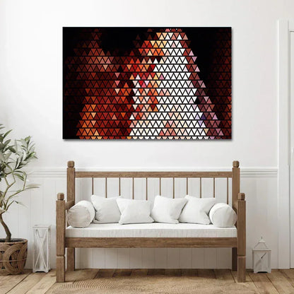 Geometric triangle pattern artwork on a wall above a wooden bench with white cushions.
