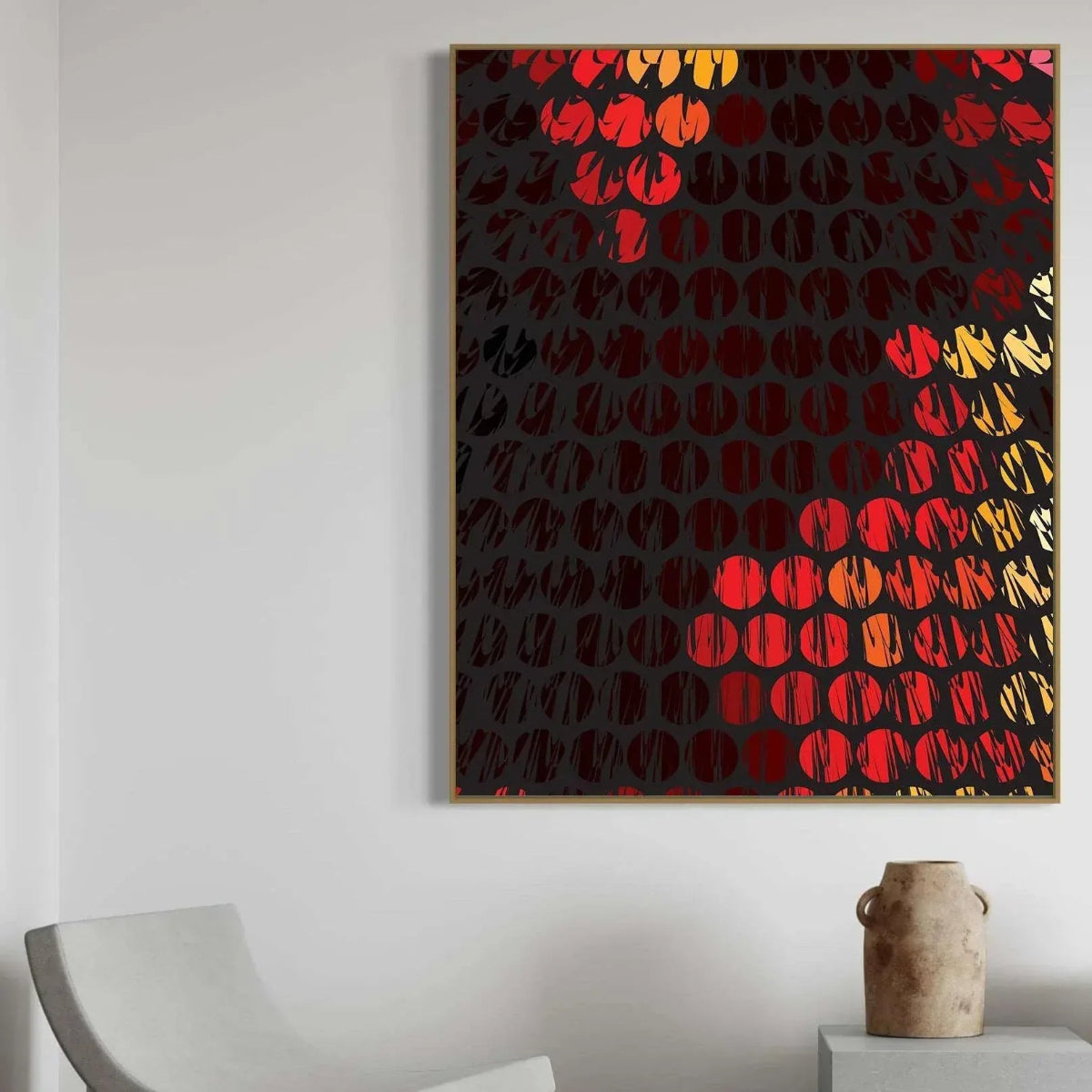 Abstract art piece with red and gold patterns on a black background, displayed on a white wall.