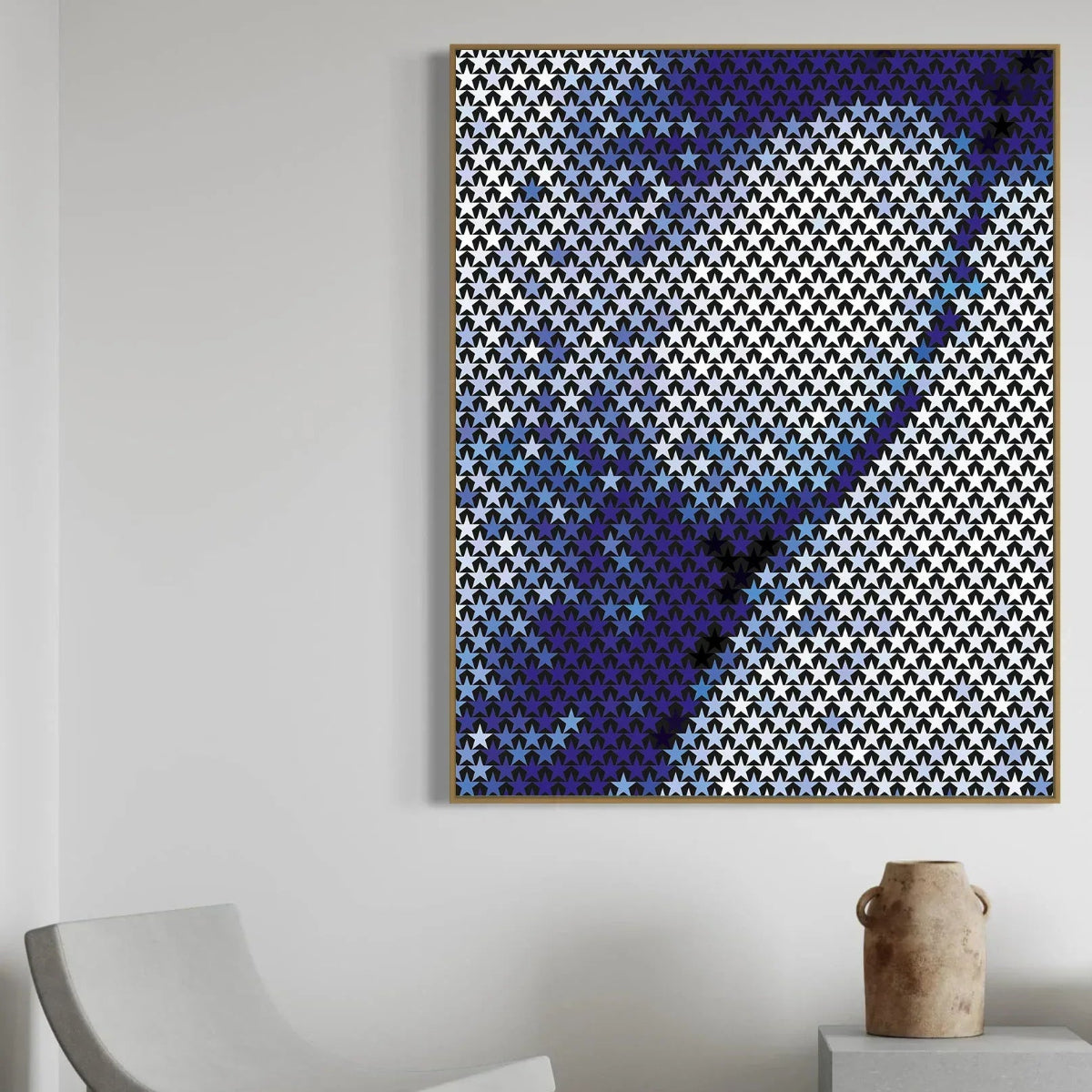 Abstract art piece with blue and white pattern on a gray wall