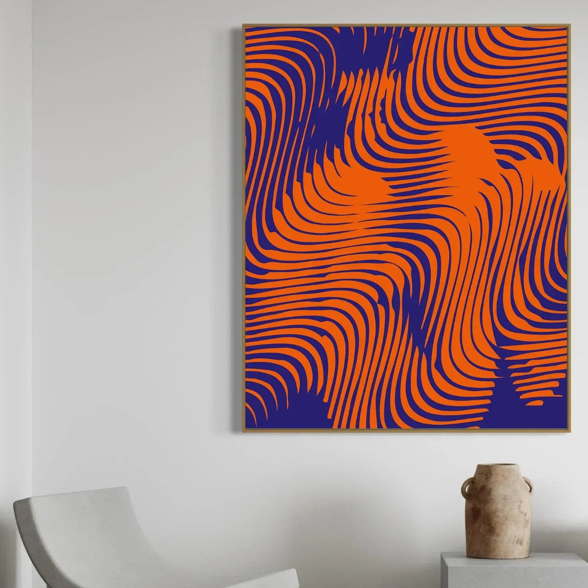 Abstract art piece with orange and blue wavy lines on a white wall.