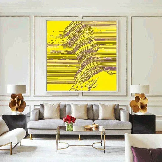 Modern living room with a gray sofa, abstract yellow painting, and decorative lamps.