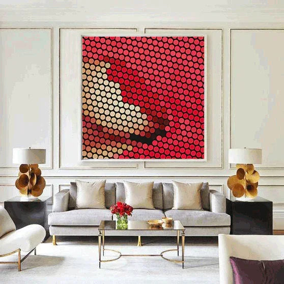 Modern living room with a gray sofa, coffee table, and abstract artwork on the wall.