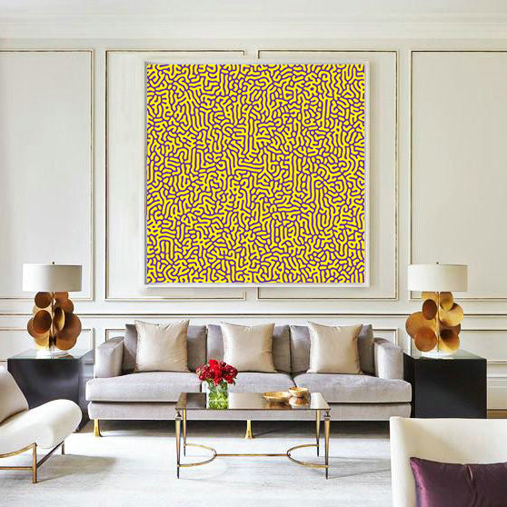 Modern living room with a gray sofa, abstract yellow painting, and decorative lamps.