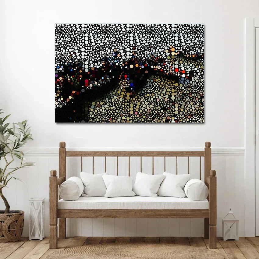 Abstract artwork on a wall above a wooden bench with white cushions.