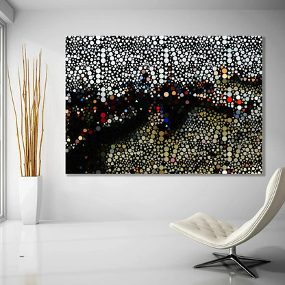 Abstract art piece with colorful dots on a white wall above a modern chair.