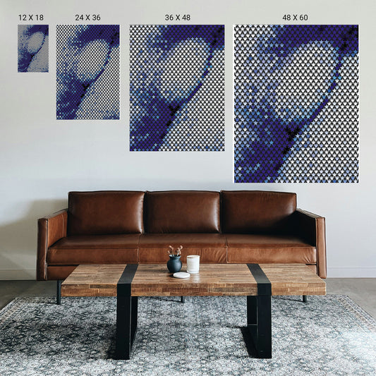 Neutral‑toned geometric symmetry artwork styled above a two‑seater sofa in a counseling office