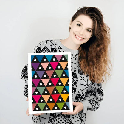 Woman holding a colorful geometric patterned frame against a white background