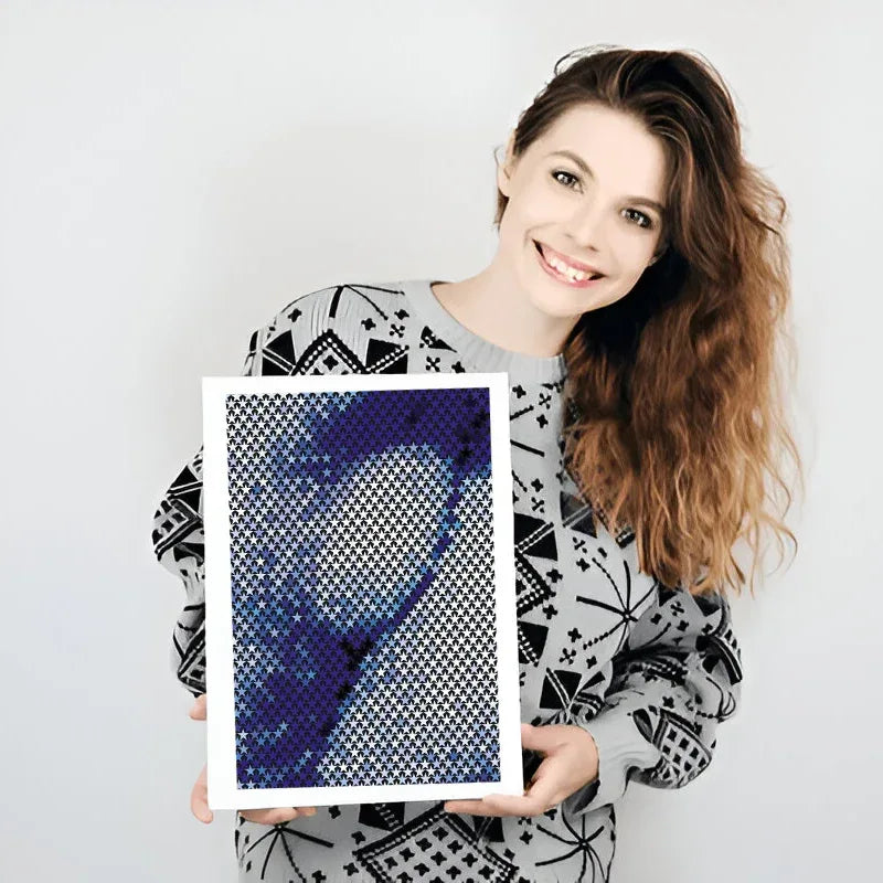 Woman holding a framed artwork with abstract design on a plain background