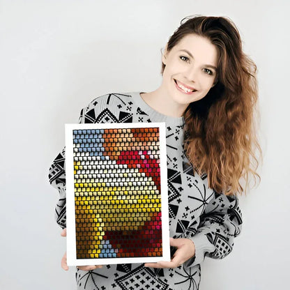 Woman holding a colorful mosaic portrait against a white background