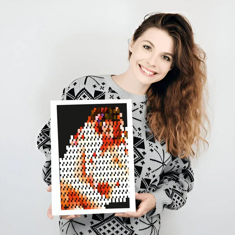 Woman holding a framed pixel art piece with a white background