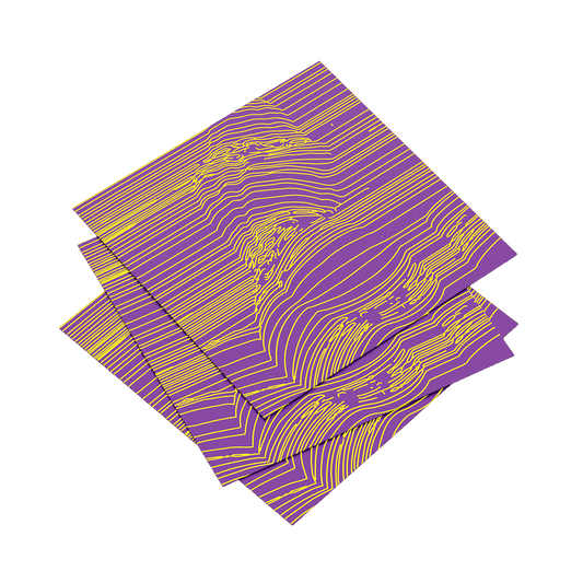 Three purple and gold patterned napkins stacked on a teal background