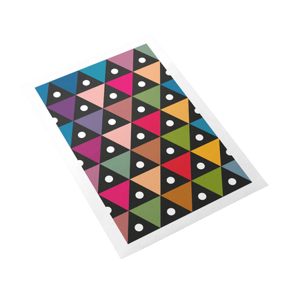 Colorful geometric patterned mat with triangles and dots on a white background