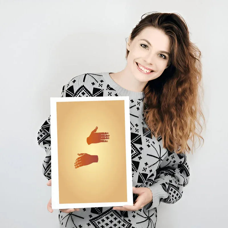 Woman holding a framed artwork with two hands on a white background