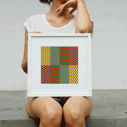 Person holding a framed colorful geometric art piece against a plain background